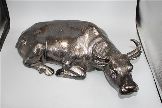 A Chinese black glazed pottery model of a seated water buffalo, length 56cm